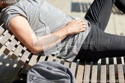 Image of man with smartphone and earphones listening music