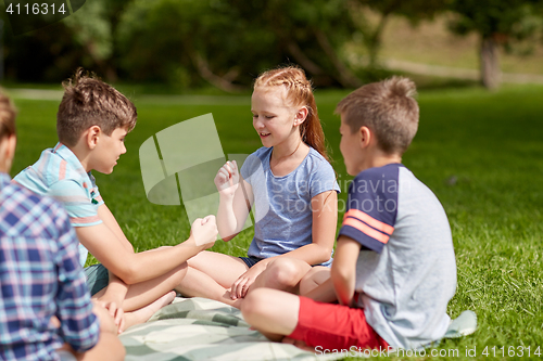 Image of happy kids playing rock-paper-scissors game