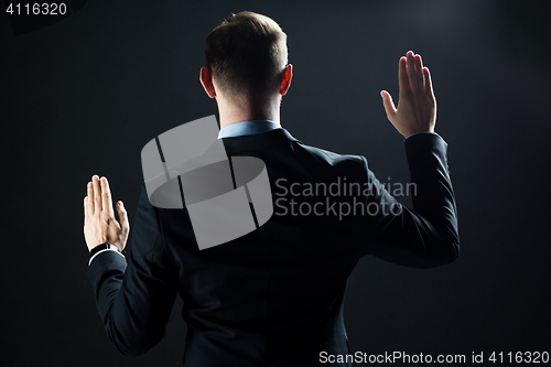 Image of businessman touching virtual screen