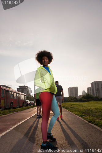 Image of Portrait of sporty young african american woman running outdoors