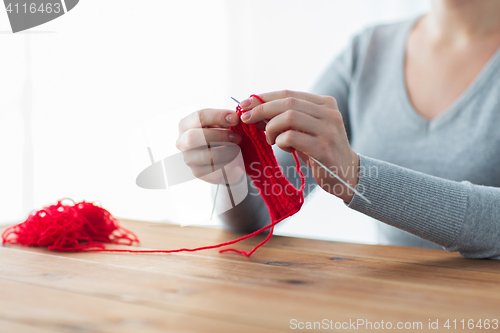 Image of woman hands knitting with needles and yarn