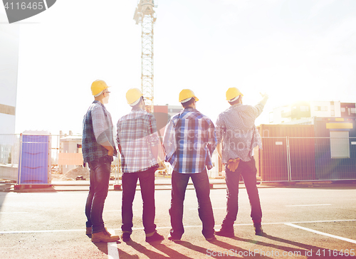 Image of group of builders in hardhats outdoors