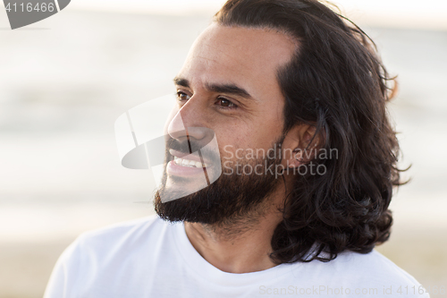 Image of happy smiling man with beard outdoors