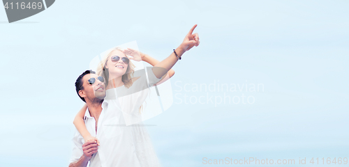 Image of couple in shades at sea side