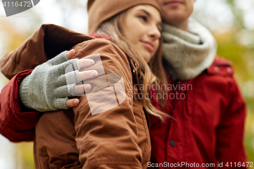 Image of close up of happy couple hugging in autumn park