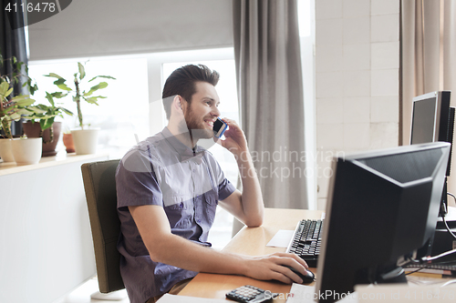 Image of happy creative male worker calling on smarphone