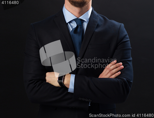 Image of businessman in suit and smartwatch