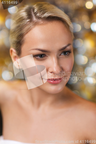 Image of close up of young woman sitting in bath towel