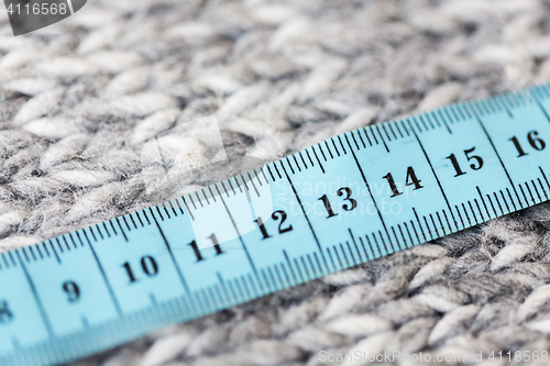 Image of close up of knitted item with measuring tape