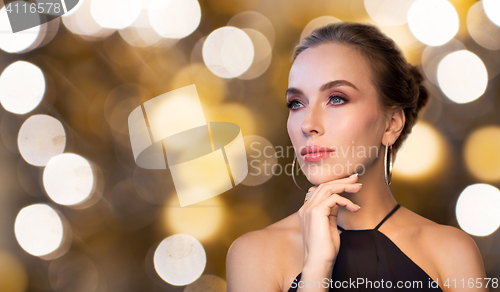 Image of beautiful woman in black wearing diamond jewelry