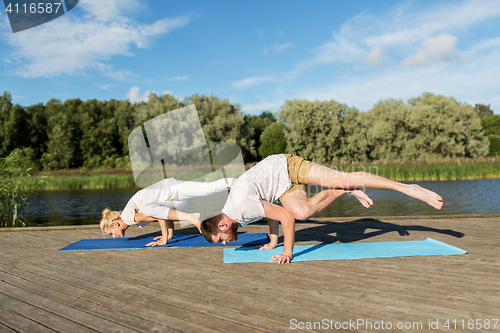 Image of people making yoga exercises outdoors