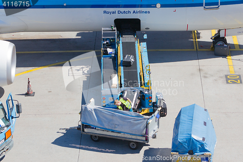 Image of AMSTERDAM, NETHERLANDS - AUGUST 17, 2016: Loading luggage in air