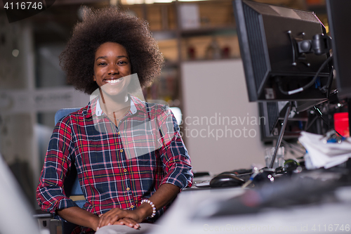 Image of young black woman at her workplace in modern office