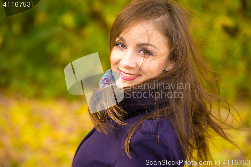 Image of Portrait of a smiling beautiful girl with disheveled hair