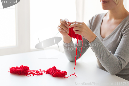 Image of woman hands knitting with needles and yarn