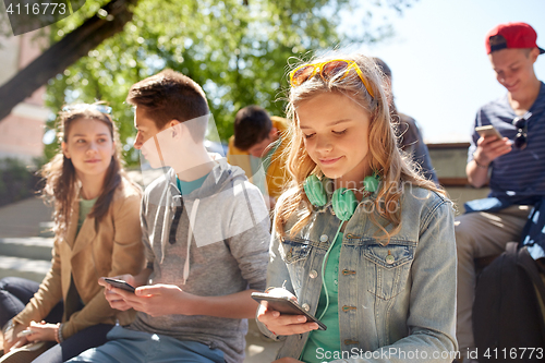 Image of teenage friends with smartphone and headphones