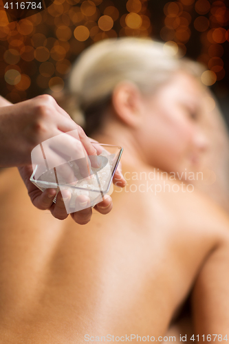 Image of close up of woman having salt massage in spa