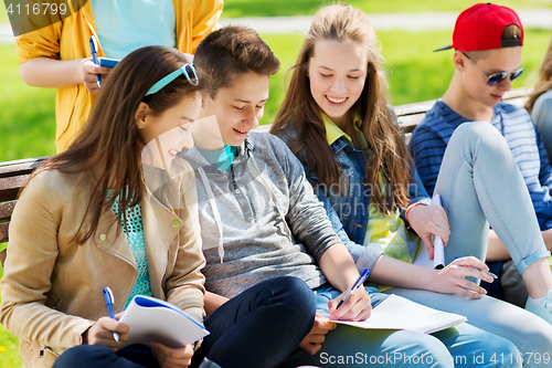 Image of group of students with notebooks at school yard