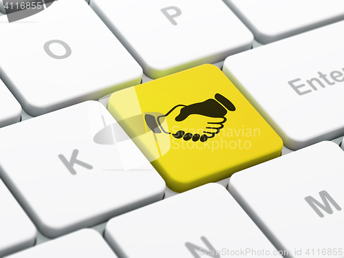 Image of Finance concept: Handshake on computer keyboard background