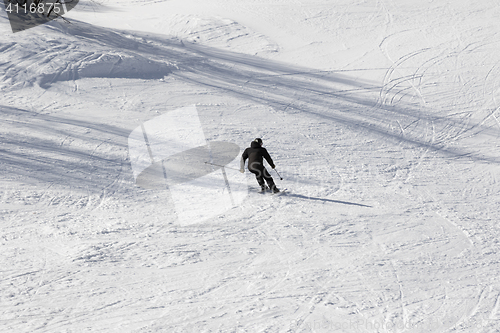Image of Skier on ski slope at sun winter day