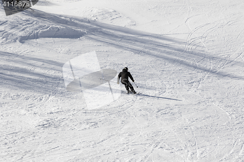 Image of Skier on ski slope at sun winter day