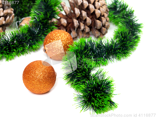 Image of Green Christmas tinsel, Christmas-tree balls and pine cones