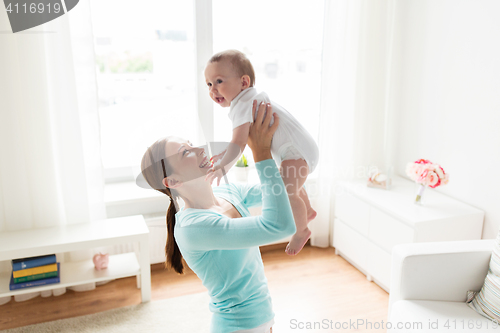 Image of happy young mother with little baby at home