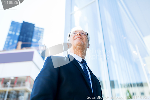 Image of senior businessman on city street