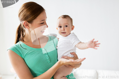 Image of happy young mother with little baby at home