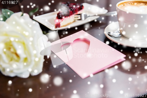 Image of close up of greeting card with heart and coffee