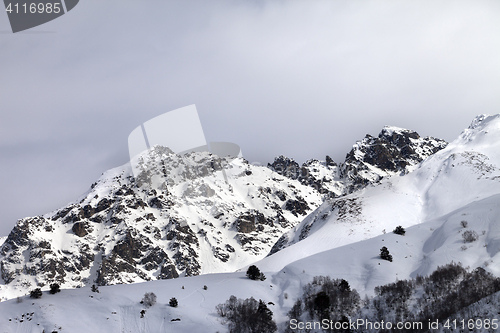 Image of Snow sunlight mountain and cloudy sky at gray evening