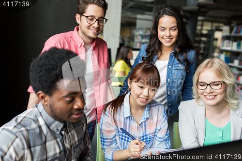 Image of international students with computers at library