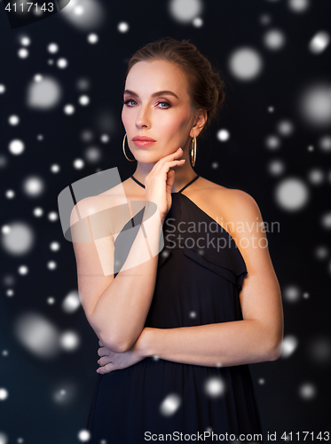 Image of beautiful woman in black wearing diamond jewelry