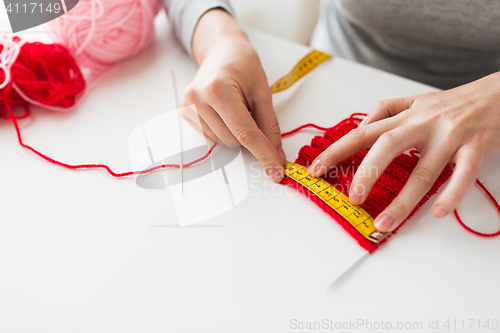 Image of woman with knitting, needles and measuring tape