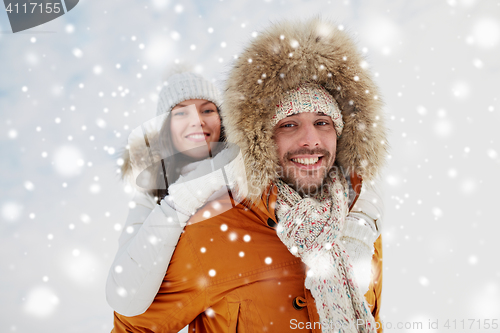 Image of happy couple having fun over winter background