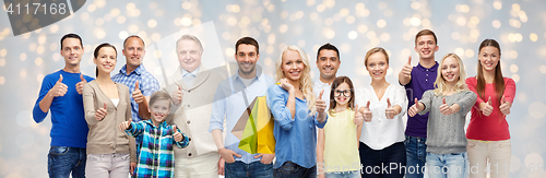 Image of happy people with shopping bags showing thumbs up