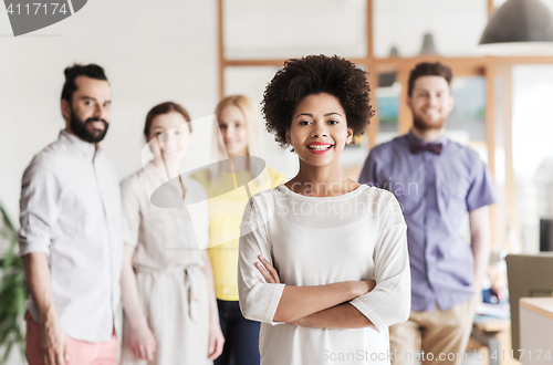 Image of happy young woman over creative team in office