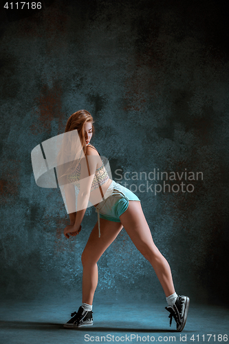 Image of Attractive girl dancing twerk in the studio