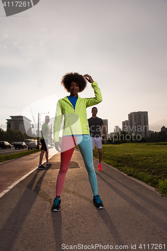 Image of Portrait of sporty young african american woman running outdoors