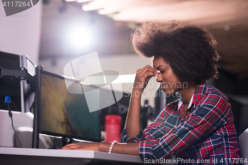 Image of a young African American woman feels tired in the modern office