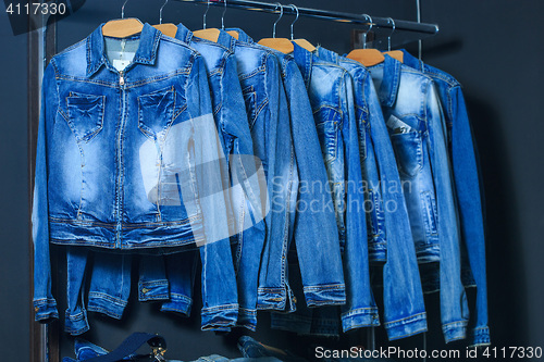 Image of fashion jeans jacket on hangers 