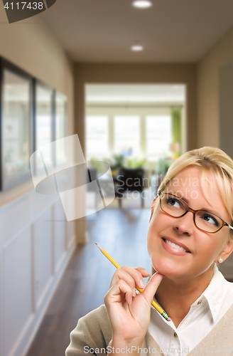 Image of Woman with Pencil Inside Hallway of House
