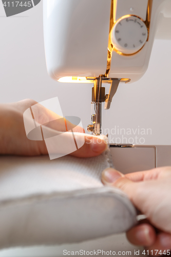 Image of Sewing machine with seamstress closeup