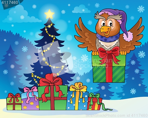 Image of Owl with gift near Christmas tree