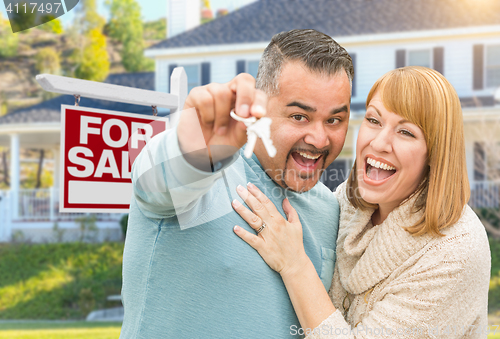 Image of Mixed Race Couple With Keys in Front of Real Estate Sign and New
