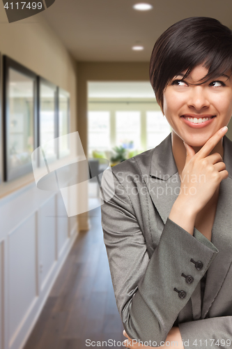 Image of Curious Mixed Race Woman Inside Hallway of House