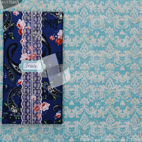 Image of Scrapbooking holder for travel documents on floral paper