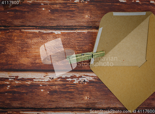 Image of Vintage envelope with pin on wood