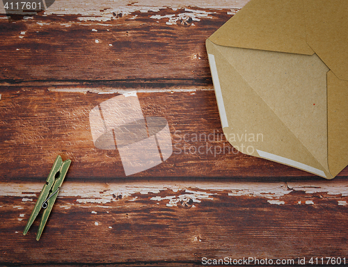 Image of Vintage envelope with pin on wood