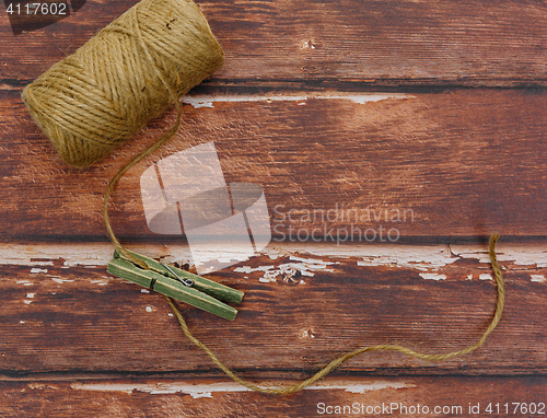 Image of Rough thread reel with pin on wood